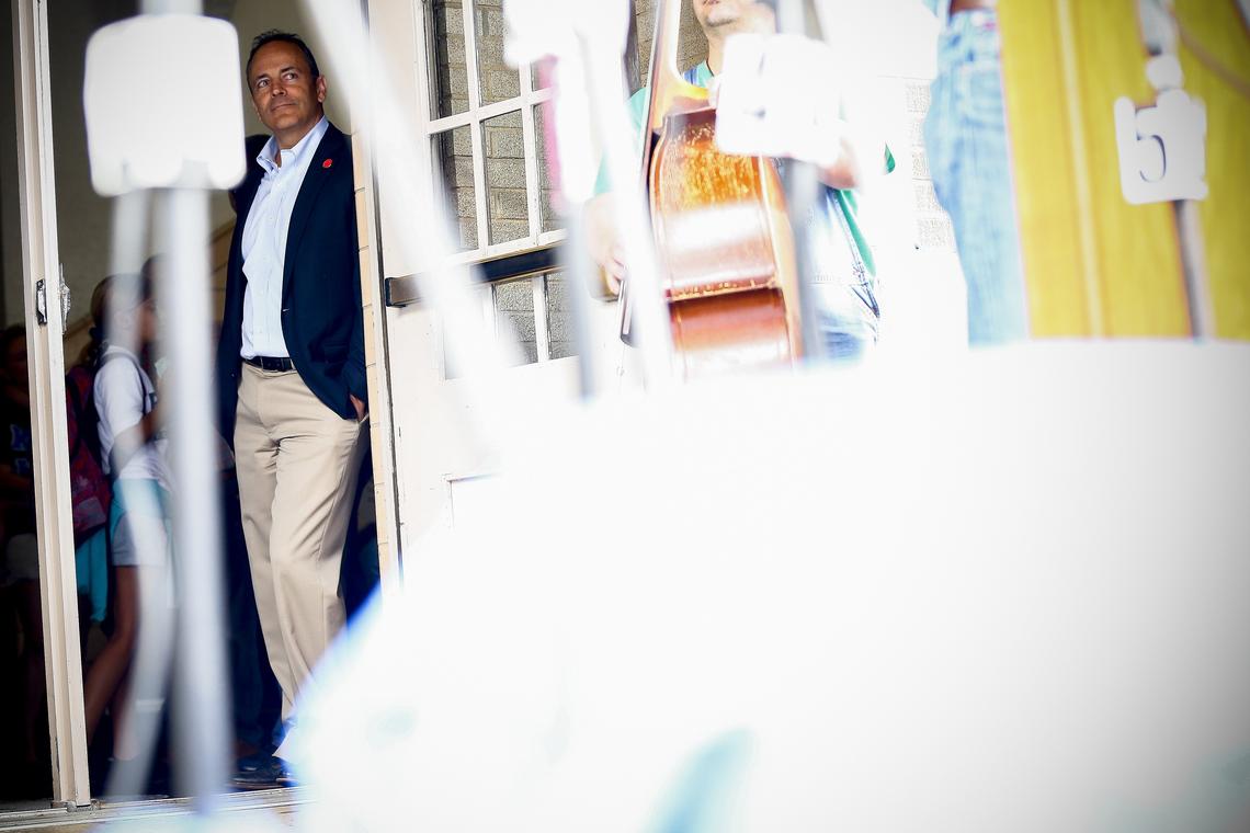 Gov. Matt Bevin listened as democratic gubernatorial candidate Adam Edelen spoke to a crowd at the Pike County Courthouse Saturday during Hillbilly Days in downtown Pikeville.