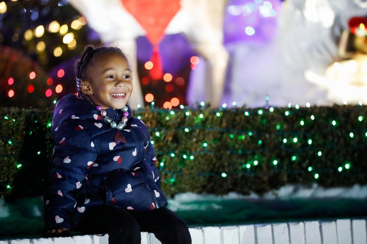 Kambri Nichols, 3, of Lexington, reacts while sitting among decorations and lights at the home of Ron and Linda Turner along Chinoe Road in Lexington, Ky., Saturday, Nov. 28.