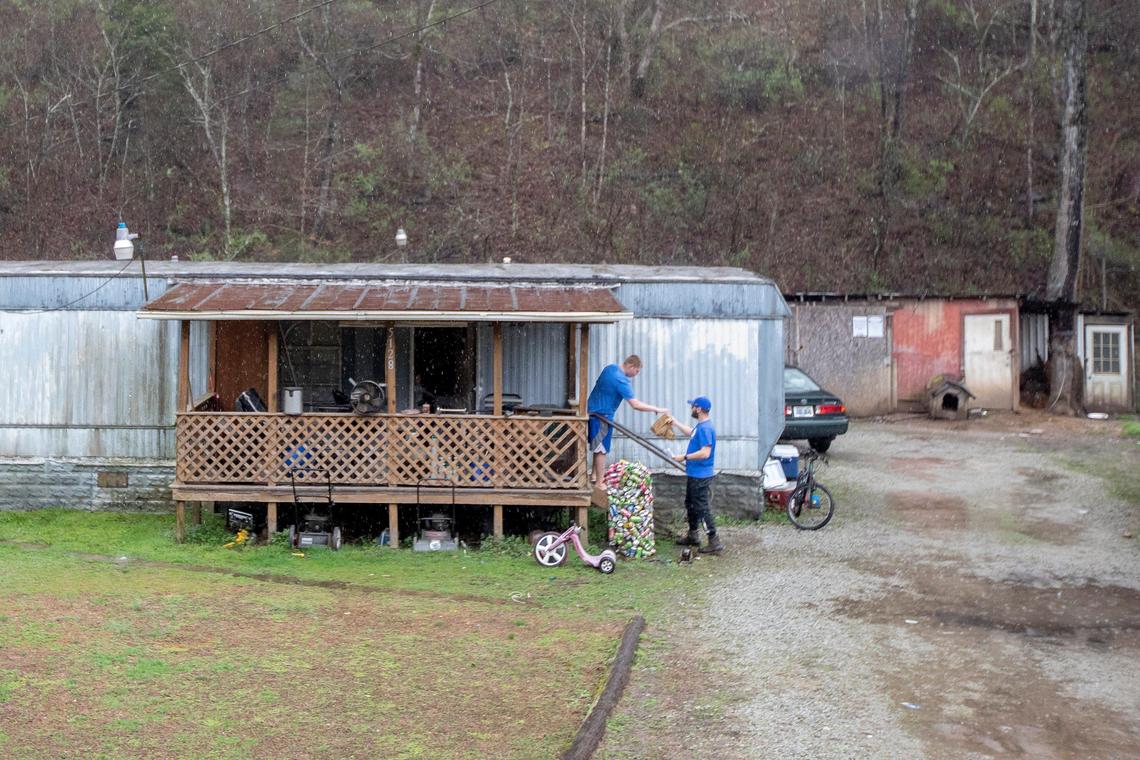 Justin Brashear, a teacher and bus driver with Floyd County Schools, delivers snacks and school work to Betsy Layne Elementary School students in Floyd County, Ky., on Thursday, March 19, 2020.