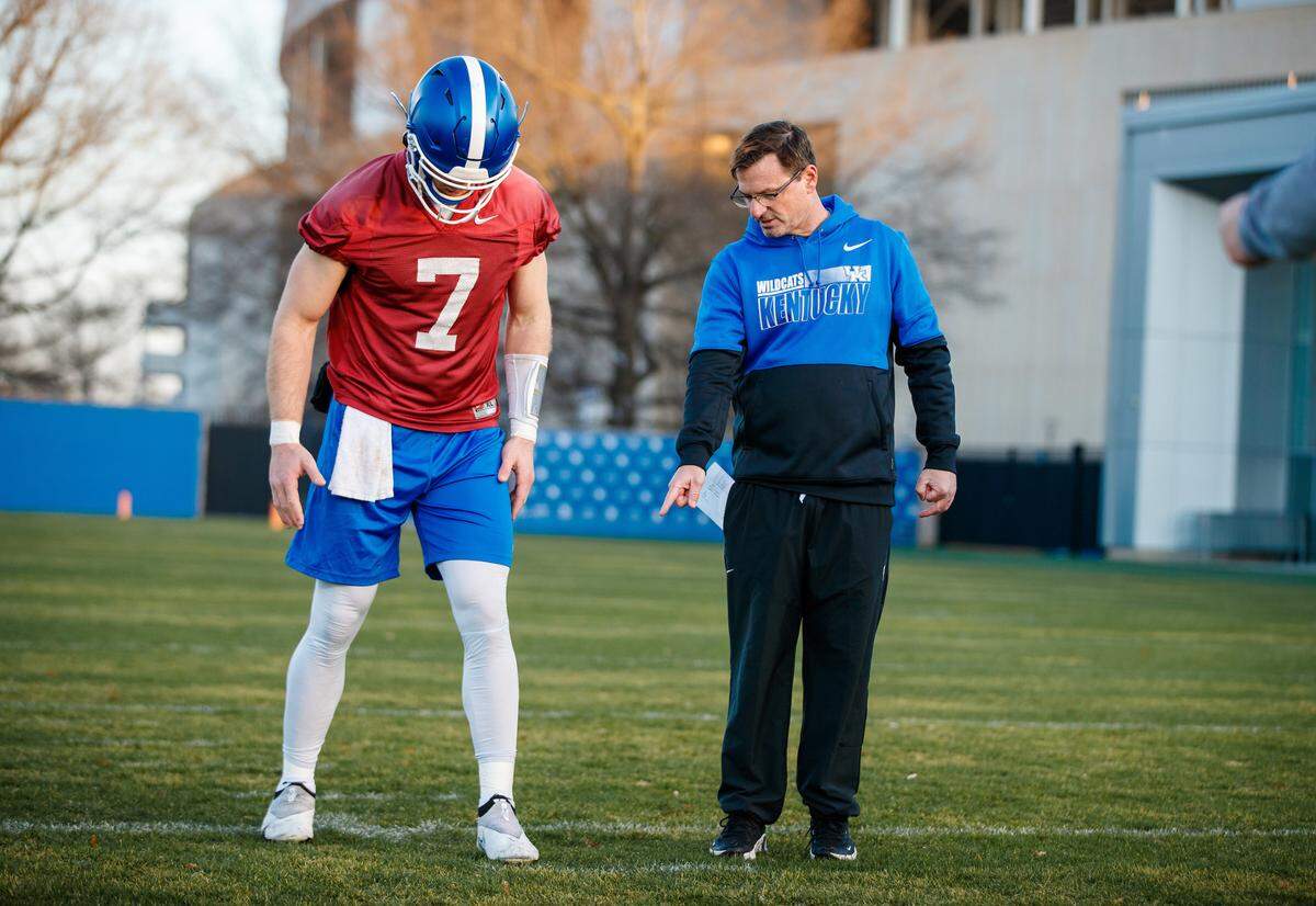 Kentucky offensive coordinator Rich Scangarello works with quarterback Will Levis during the Wildcats’ spring football practice on March 22 at the Joe Craft Football Training Facility.