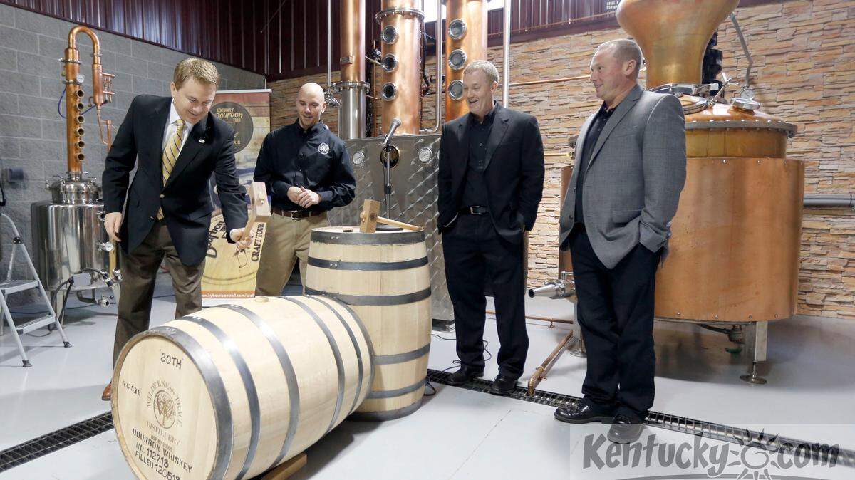 Kentucky Commissioner of Agriculture James Comer tapped the bung in a barrel of bourbon whiskey that was filled yesterday,  during the grand opening ceremony at Wilderness Trace Distiller, 445 Roy Arnold Dr. in Danville, Ky., Friday, December 6, 2013. The grand opening featured a ribbon cutting and barreling ceremony along with a celebratory toast. Beside him  L-R:  Jerod Smith, Shane Baker, Pat Heist. Photo by Charles Bertram | Staff
