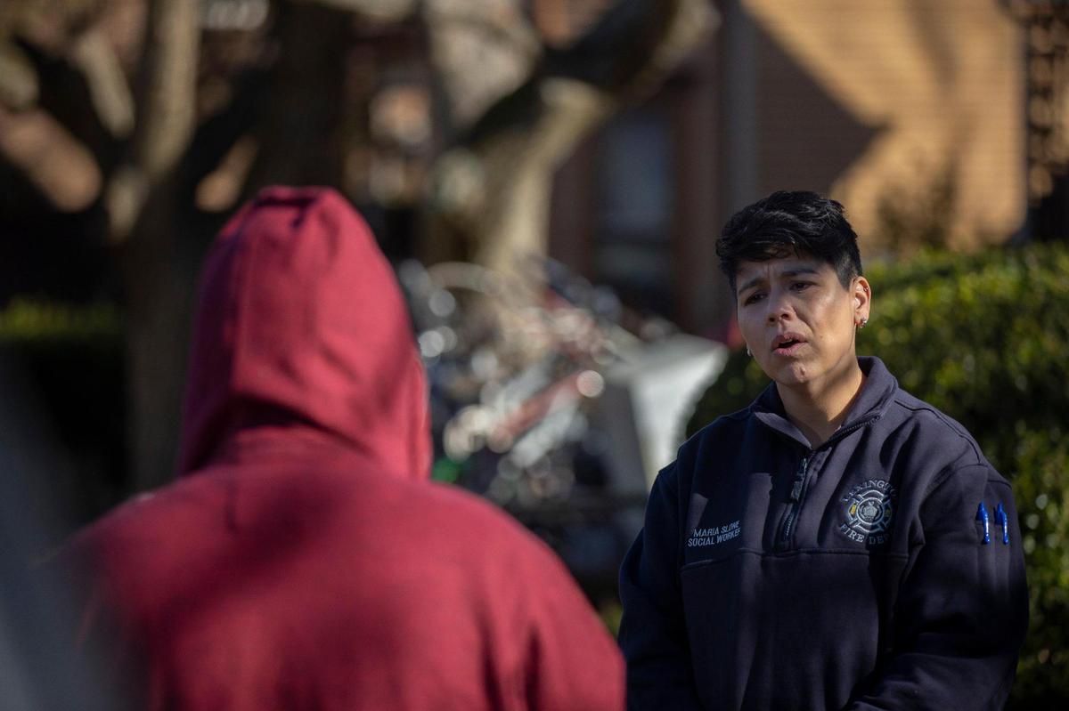 Lexington Fire Department social worker Maria Slone talks with a person near a location where someone had recently overdosed on opioids and been revived in Lexington, Ky., on Monday, Nov. 29, 2021.