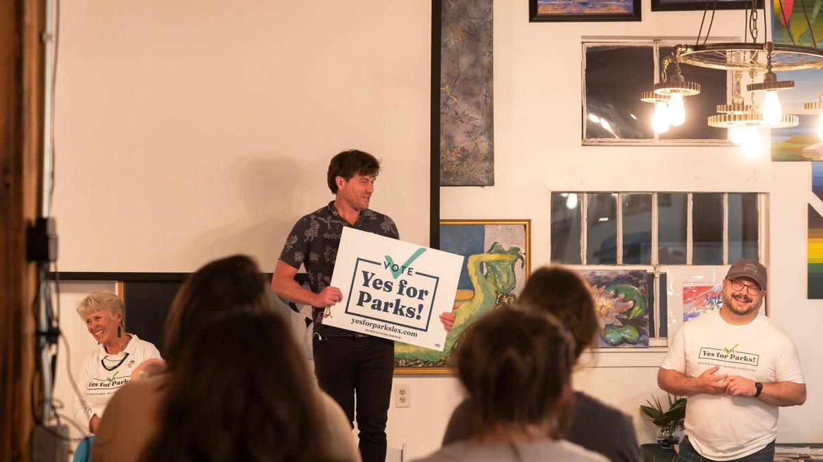 Standing, from left, Victoria Meyer, Griffin VanMeter and Dave Lowe, some of the main supporters of the Vote Yes for Parks! Campaign, speak during an Election Night party for supporters at Pasta Garage in Lexington, Ky., on Tuesday, Nov. 5, 2024.