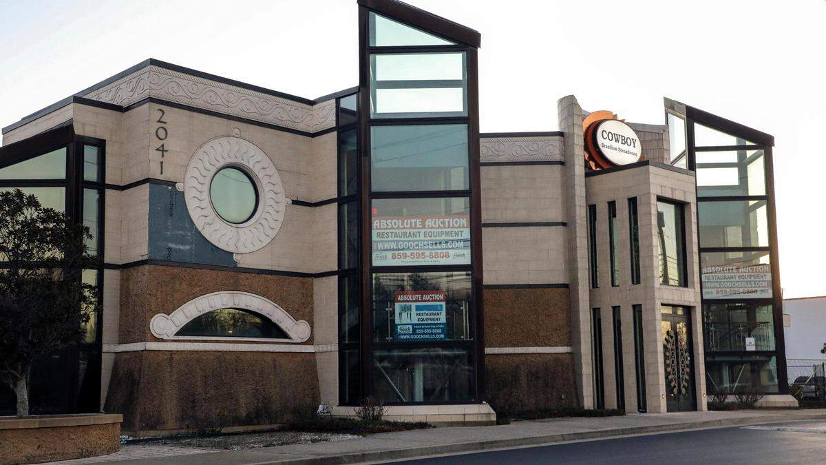 One of Lexington’s most unique and largest restaurant buildings at 2041 Richmond Road, sits empty Tuesday, Dec. 19, 2023, in Lexington, Ky. with absolute auction signs in its windows for the restaurant’s equipment. The restaurant was home for two Lexington dining spots that ultimately closed. Originally opened in March 2013 as Coba Cocina, the building was known for its jellyfish tank, but the restaurant closed after three years of operation. Cowboy Brazilian Steakhouse opened in fall 2018 and closed less than a year later. The building has sat empty since then.