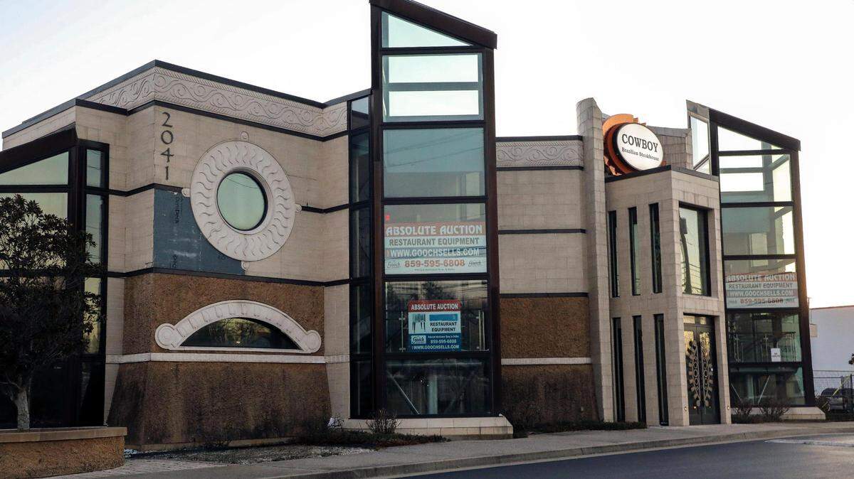 One of Lexington’s most unique and largest restaurant buildings at 2041 Richmond Road, sits empty Tuesday, Dec. 19, 2023, in Lexington, Ky. with absolute auction signs in its windows for the restaurant’s equipment. The restaurant was home for two Lexington dining spots that ultimately closed. Originally opened in March 2013 as Coba Cocina, the building was known for its jellyfish tank, but the restaurant closed after three years of operation. Cowboy Brazilian Steakhouse opened in fall 2018 and closed less than a year later. The building has sat empty since then.