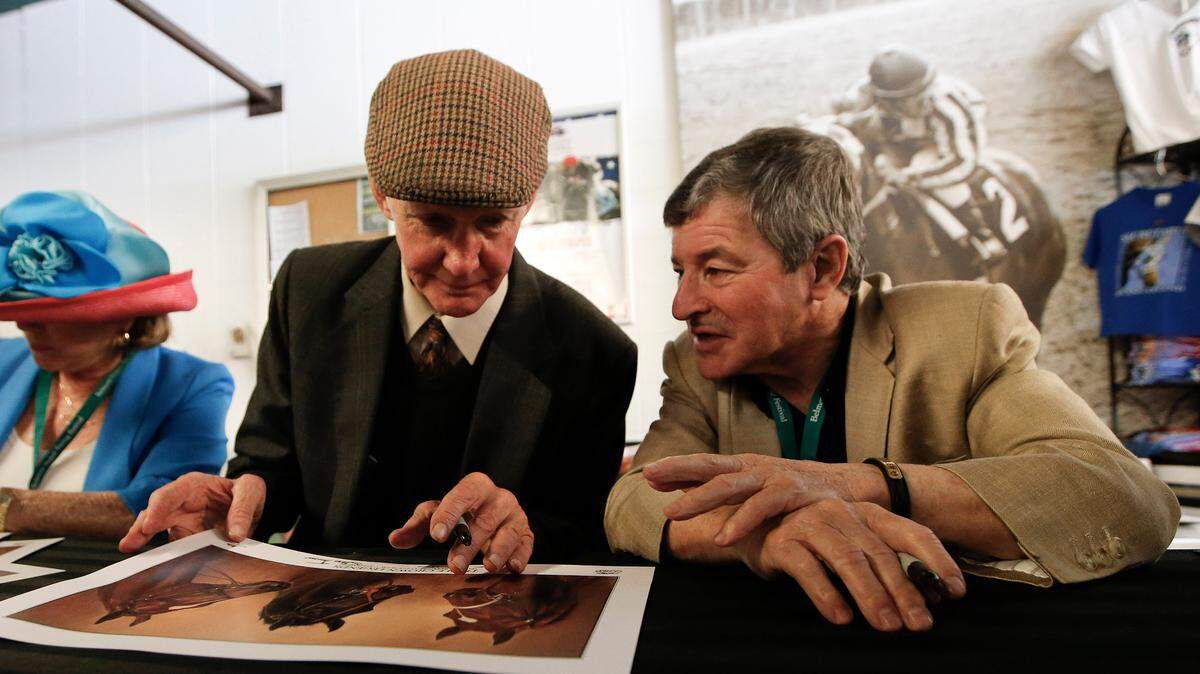 Billy Turner, left, trainer for Seattle Slew, and Jean Cruguet, Seattle Slew’s jockey, signed autographs for horse racing fans before the 2015 Belmont Stakes in Elmont, N.Y. Seattle Slew won the Triple Crown in 1977.