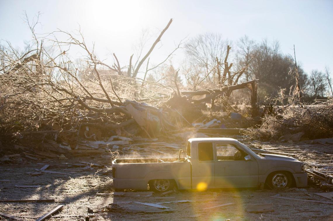 Steam rises of a wrecked tuck as the sun rises in neighborhoods hit by a tornado off of Russellville Road in Bowling Green, Ky., Sunday, December 12, 2021.