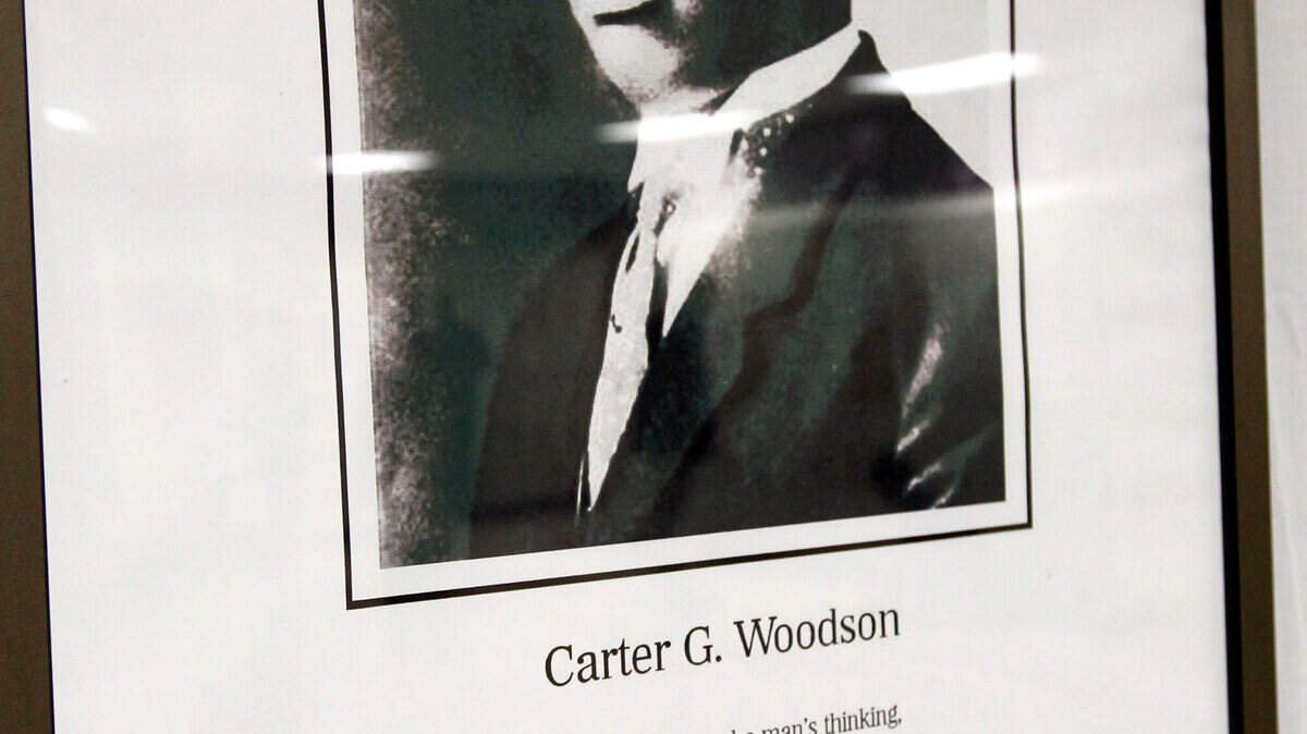 A plaque honoring Carter G. Woodson is on the wall at the Woodson Academy. Photo by Charles Bertram | Staff