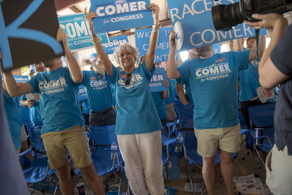 Supporters of U.S. Representative James Comer raised their signs during his speech Saturday, August 4, 2018, in Fancy Farm, Ky 
