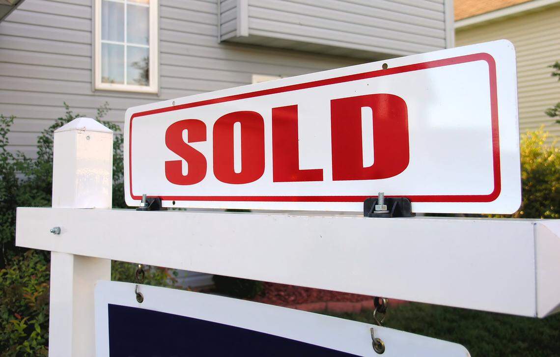 Real estate sold sign.