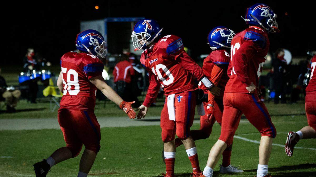 Mercer County Titans junior quarterback Trosper Buchanan high-fives his teammates as they run onto the field before the game against the Henry County Wildcats on Friday, Oct. 16, 2020, in Harrodsburg, Ky. The Titans defeated the Wildcats 49-14.
