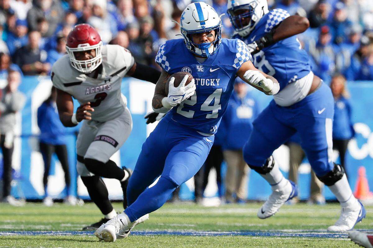 Kentucky Wildcats running back Chris Rodriguez Jr. (24) carries the ball past New Mexico State Aggies linebacker Chris Ojoh (3) during a game at Kroger Field in Lexington, Ky., Saturday, Nov. 20, 2021.