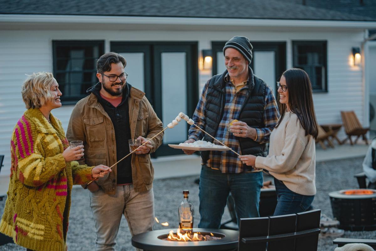 Guests at the Bardstown Motor Lodge roast marshmallows for s’mores in the courtyard in Bardstown, Ky.