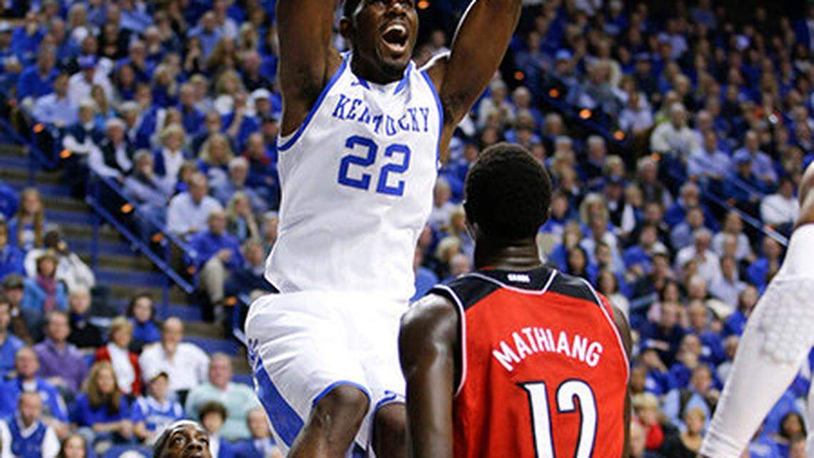 Kentucky's Alex Poythress dunked over Louisville forward/center Mangok Mathiang (12) as then #18 Kentucky defeated #6 Louisville 73-66 on Saturday Dec. 28, 2013 in Lexington ,Ky. Photos by Mark Cornelison | Staff