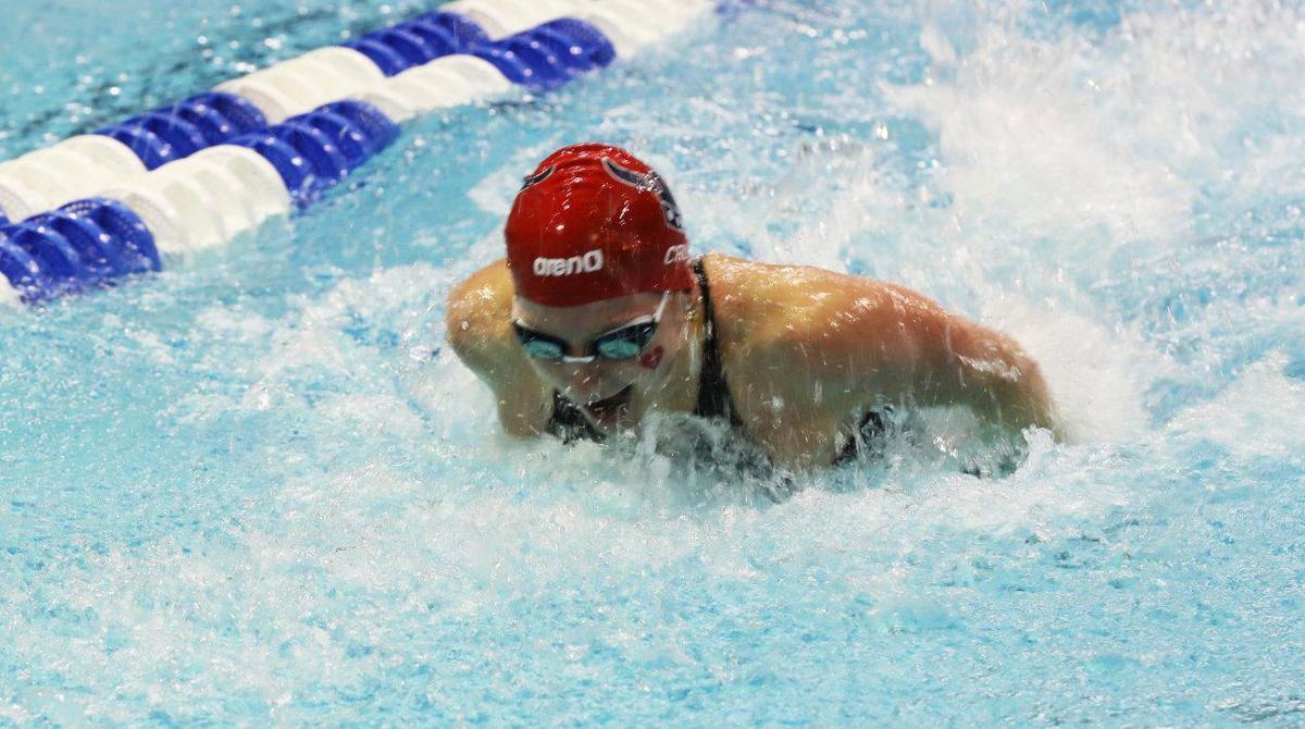 Charlotte Crush breaks her own state record in the 100-yard butterfly on Saturday morning in the girls state preliminaries.