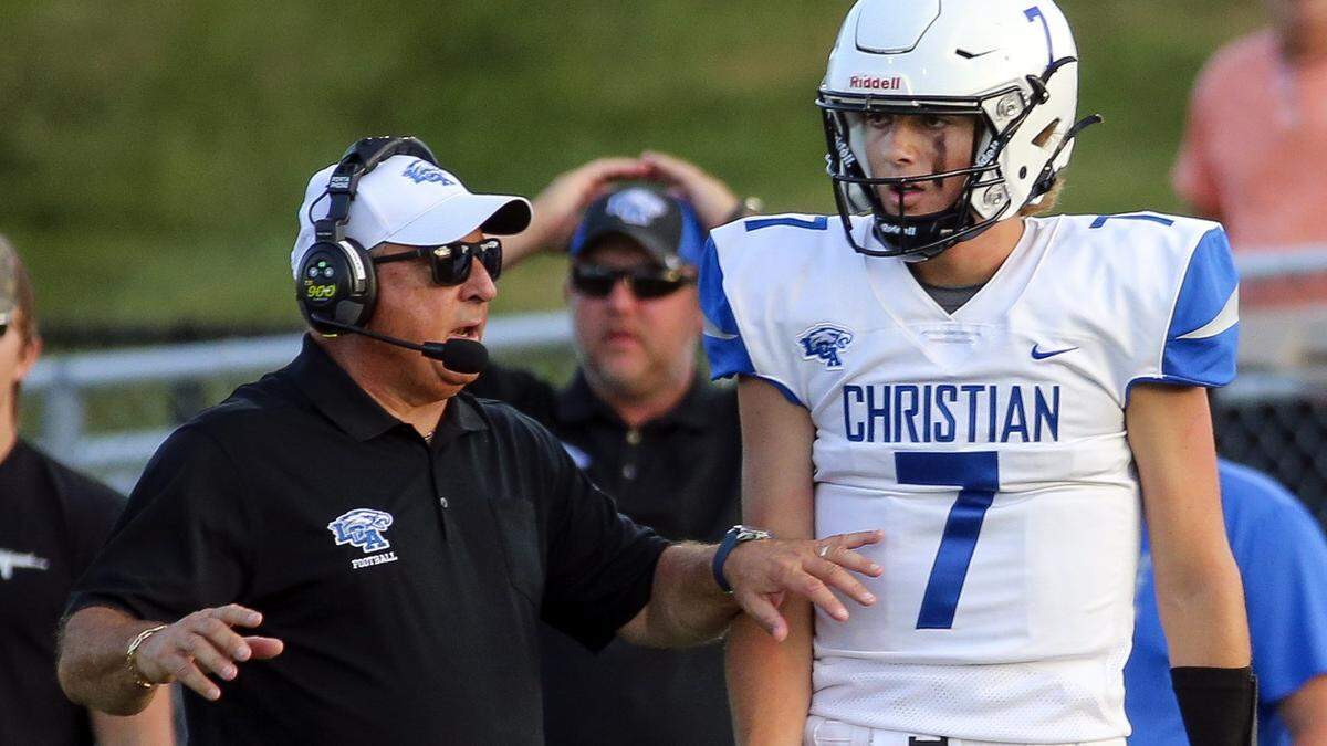 Lexington Christian quarterback Cutter Boley talks with head coach Doug Charles, left, during Friday night’s game in Richmond. Boley passed for 367 yards in his LCA debut.