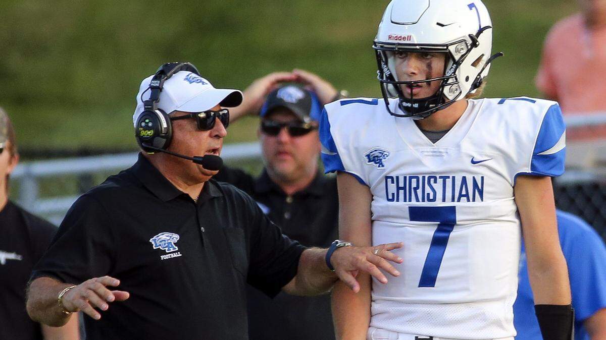 Lexington Christian’s Cutter Boley (7) talks with head coach Doug Charles during the team’s season-opening game against Madison Central on Aug. 19. Boley left Friday’s home game due to injury in the second half.