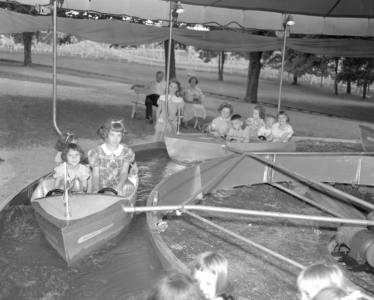 Picture of Connie Adams and Mary Emma Lowery riding a small boat at Joyland Amusement Park. 