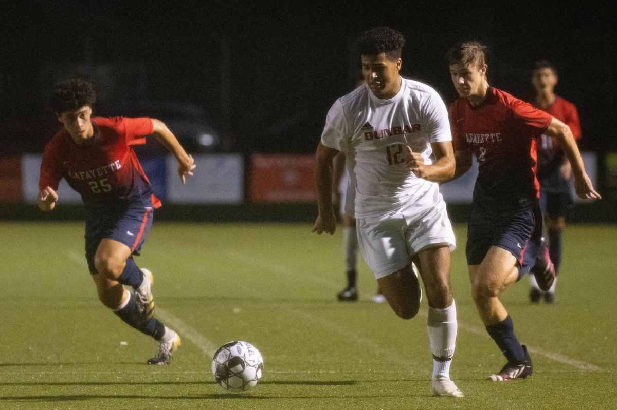 Dunbar’s Antonio Blackman (12) dribbles upfield during the Bulldogs’ 9-2 win over rival Lafayette. Blackman was among seven players who scored goals for Dunbar.