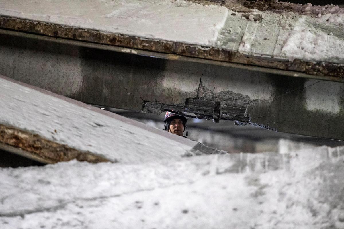 Members of the Lexington Fire Department respond to a parking garage that partially collapsed near South Mill and West High streets in Lexington, Ky., on Thursday, Feb. 18, 2021.