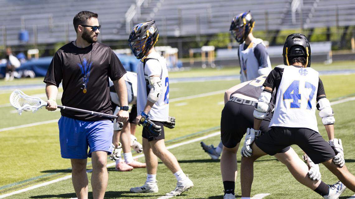 Henry Clay boys lacrosse coach Ben Ternosky talks to his players during their warm up for practice at Henry Clay High School on Monday.