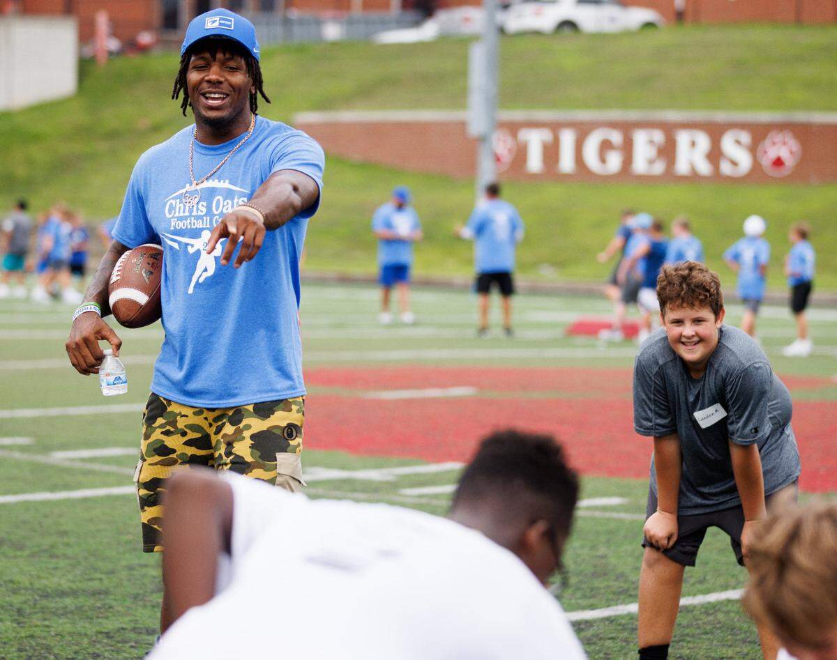 Kentucky linebacker J.J. Weaver laughs while running a drill during the Chris Oats Football Camp. “It’s a blessing to see Chris doing this,” Weaver said. “… It’s a blessing to see him overcome so much.”