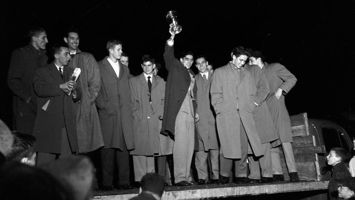 Walt Hirsch held the trophy as the University of Kentucky basketball team returned to Blue Grass Field after winning the NCAA championship in 1951. UK had defeated Kansas State 68-58 in the title game in Minneapolis.