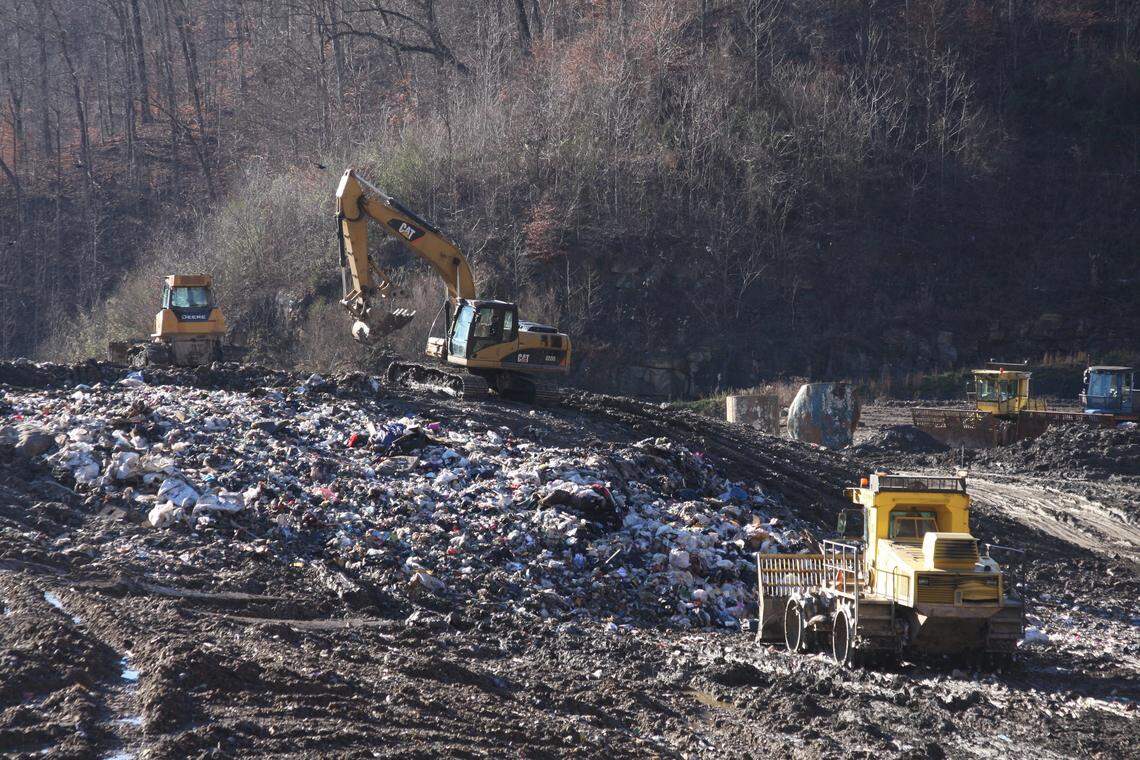 Workers use heavy equipment to compact and store solid waste at the Pike County landfill on Tuesday, Dec. 18, 2018.
