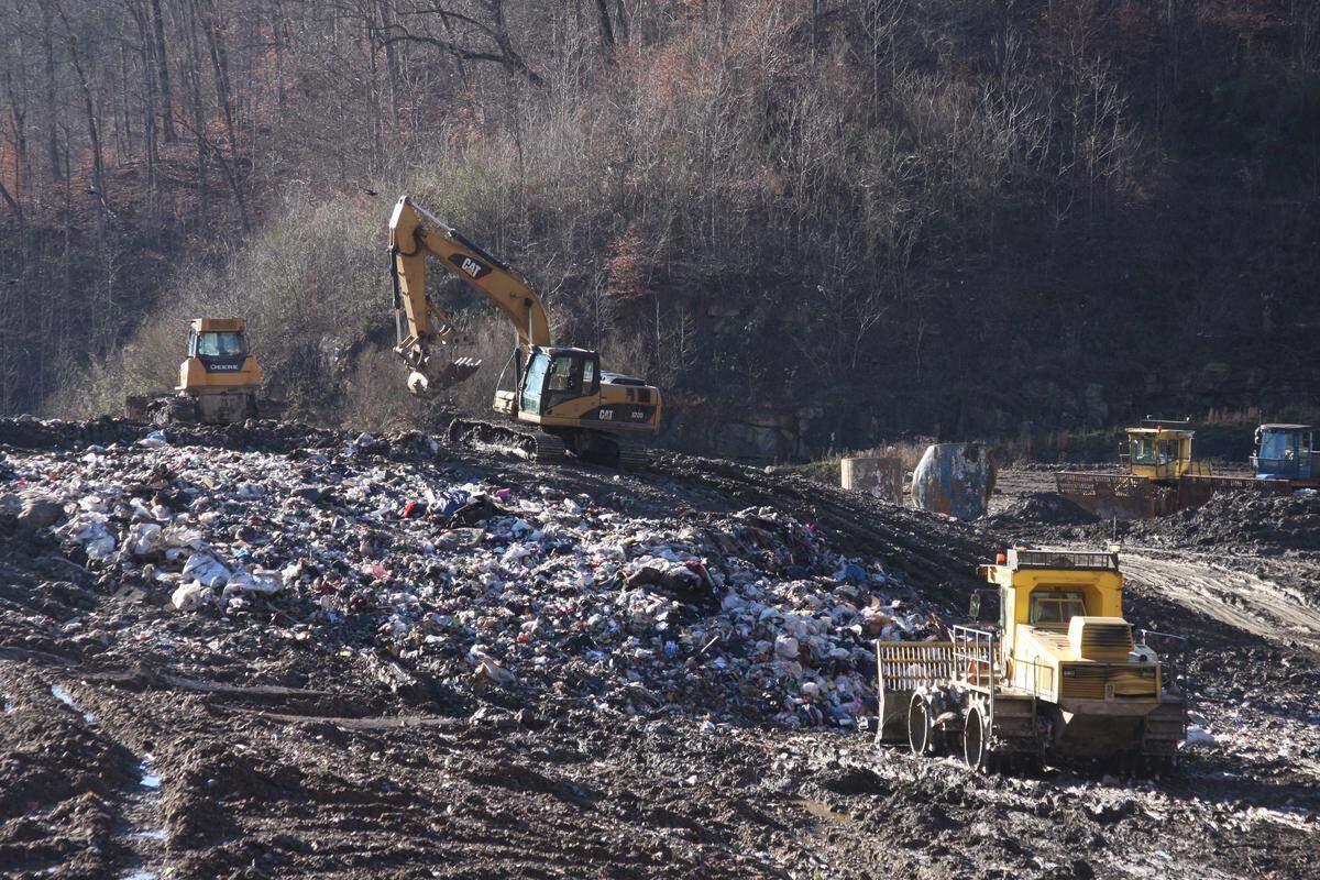 Workers use heavy equipment to compact and store solid waste at the Pike County landfill on Tuesday, Dec. 18, 2018.