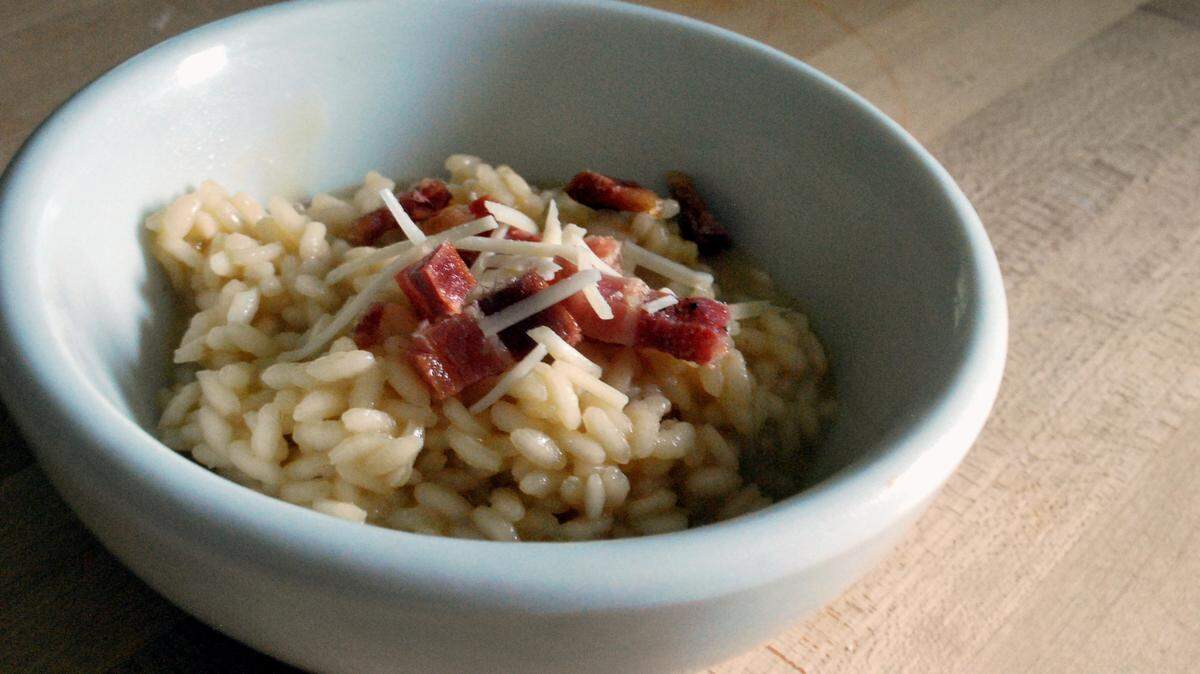 Home-cured bacon tops this creamy risotto and also is mixed into the Arborio rice. Recipe on Page B4.
