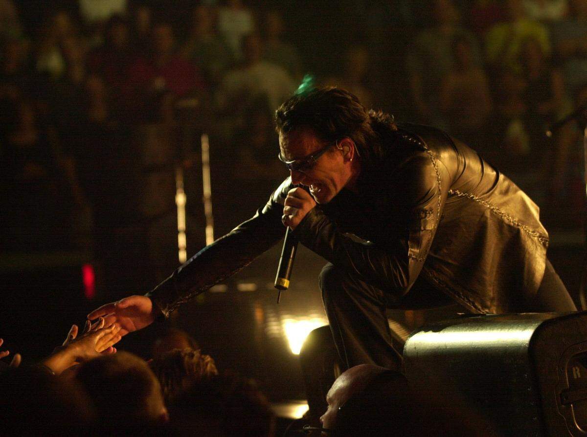 Bono, lead singer to the band U2, reached out and touched some hands at their performance at Rupp Arena in Lexington Ky., May, 4, 2001.
