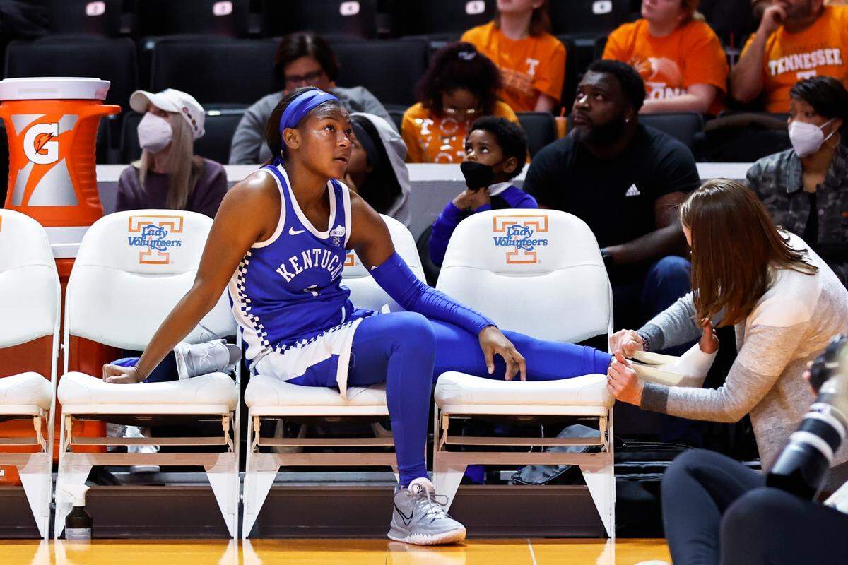 Kentucky guard Robyn Benton, left, has her ankle taped after being injured during Sunday’s game against Tennessee.