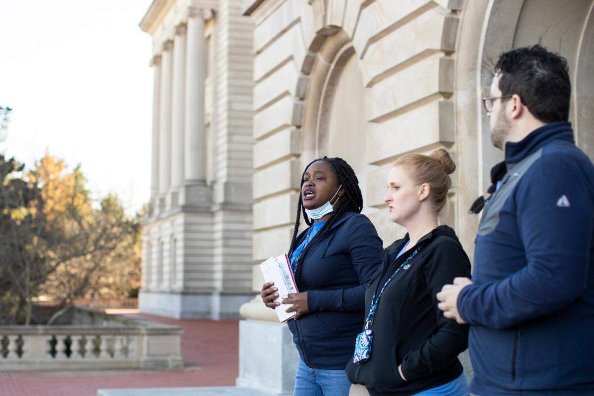 Shawnte West speaks to social workers with the Department for Community Based Services gathered on the steps of the Kentucky Capitol in Frankfort on Tuesday to advocate for pay rates and to protest staffing shortages in their ranks.