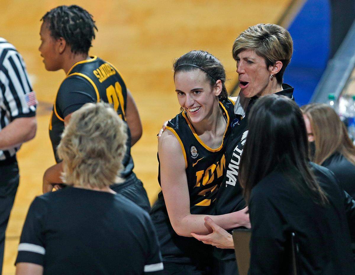 Iowa assistant coach Jen Jensen hugs Iowa guard Caitlin Clark (22) as she comes to the bench after scoring 35 points in the Hawkeyes’ 86-72 women’s NCAA Tournament win over Kentucky.