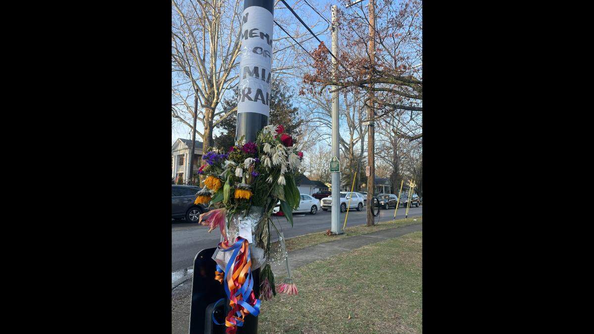 A flower memorial for Mia Ibrahim, who was killed in a fatal crash, is posted on a crosswalk sign at the intersection of Rosemont Garden and Nicholasville Road, where Ibrahim was killed in a crash.