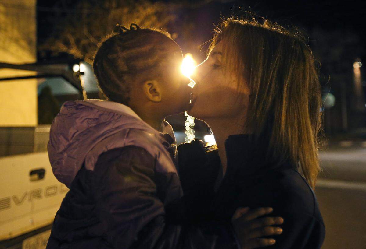 Virginia women’s basketball coach Joanne Boyle, right, got a kiss from her adopted daughter, Ngoty, in Charlottesville, Va., in 2015. As of last summer, Boyle had still been unable to secure U.S. citizenship for Ngoty, who was born in Senegal.