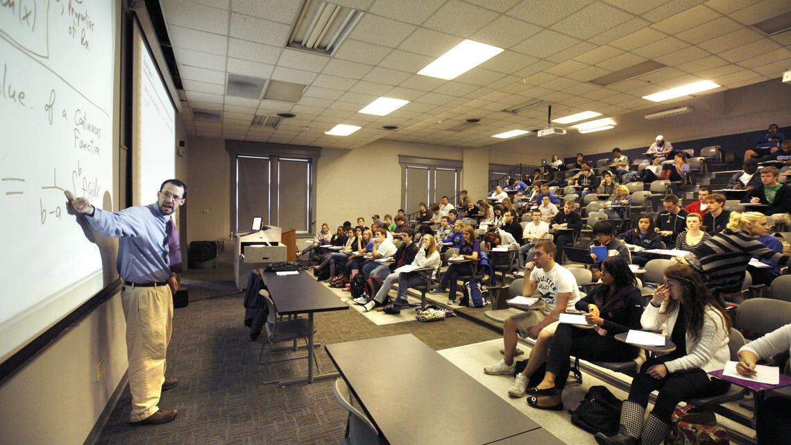 Paul Koester, left, taught an elementary calculus class at the University of Kentucky's Kastle Hall. About 160 are enrolled for this lecture course. Outgoing UK president Lee T. Todd Jr. has proposed a number of improvements, including smaller classes, to go along with UK's tuition hike.    