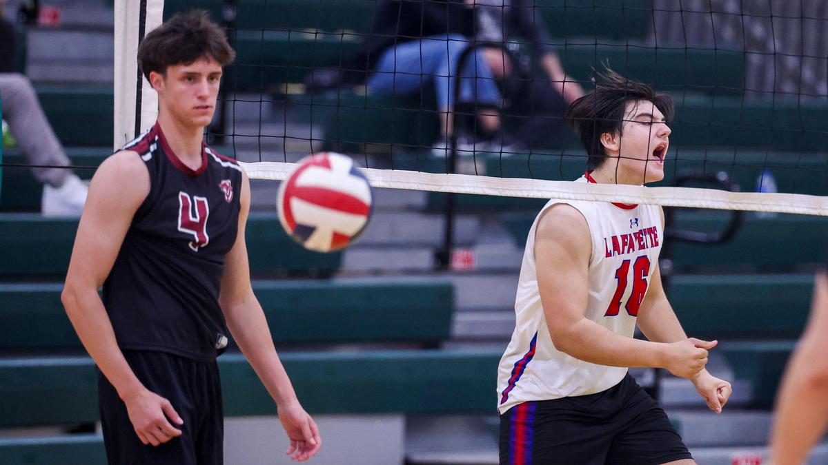 Lafayette’s Jaiden Vanover, right, celebrates after a point as Tates Creek’s Tom Haubenreich watches during the Generals’ 3-1 win over the Commodores in the 7th Region Boys Volleyball Tournament on Thursday at Bryan Station High School.