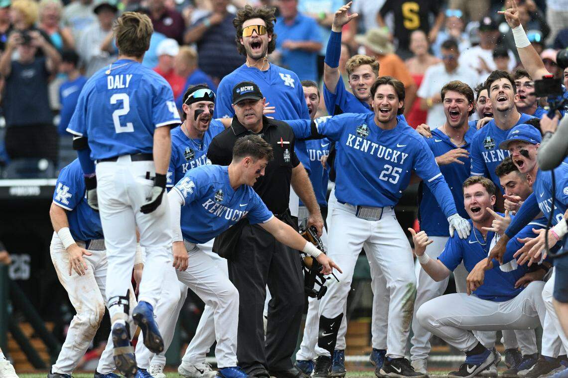Kentucky Wildcats third baseman Mitchell Daly (2) and teammate celebrate after hitting a walk off home run against the NC State Wolfpack during the tenth inning at Charles Schwab Filed in Omaha, NE on June 15, 2024.