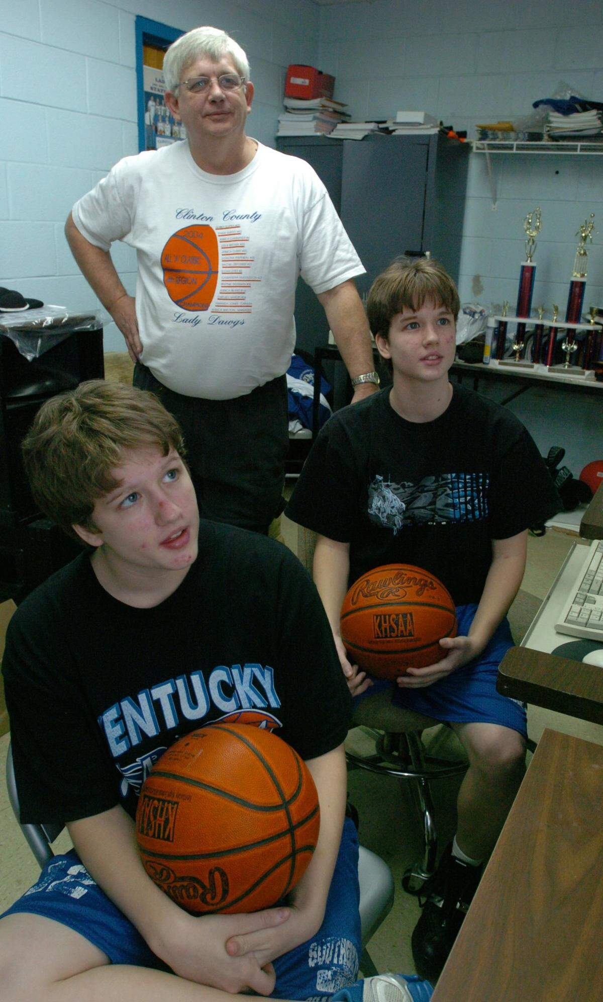 January 2005 file photo: Twins Amber, left, and Paige Guffey watched video of one of their games with their dad, Ronnie Guffey, then their head coach at Clinton County High School. Ronnie Guffey died Tuesday.