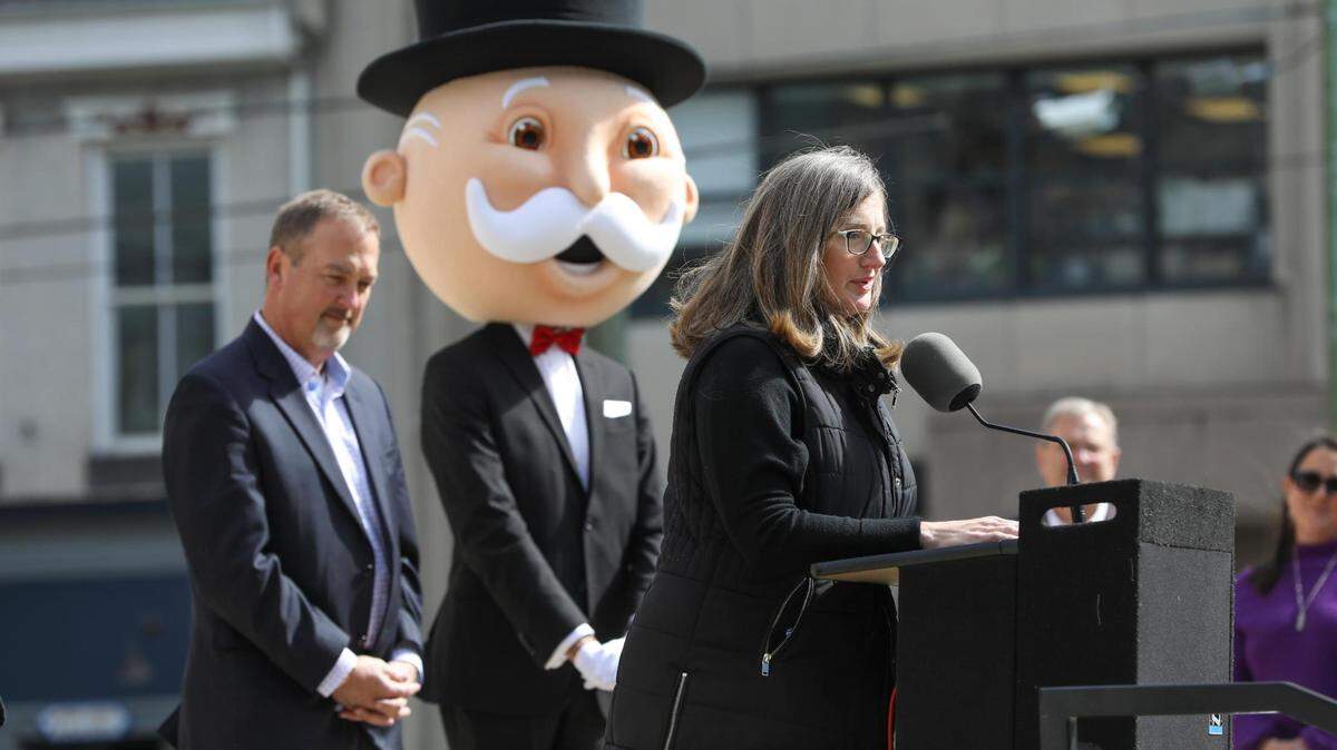 VisitLEX President Mary Quinn Ramer speaks during the Monopoly Lexington edition announcement Oct. 20, 2022. Pictured at left is Kentucky Department of Tourism Commissioner Mike Mangeot.