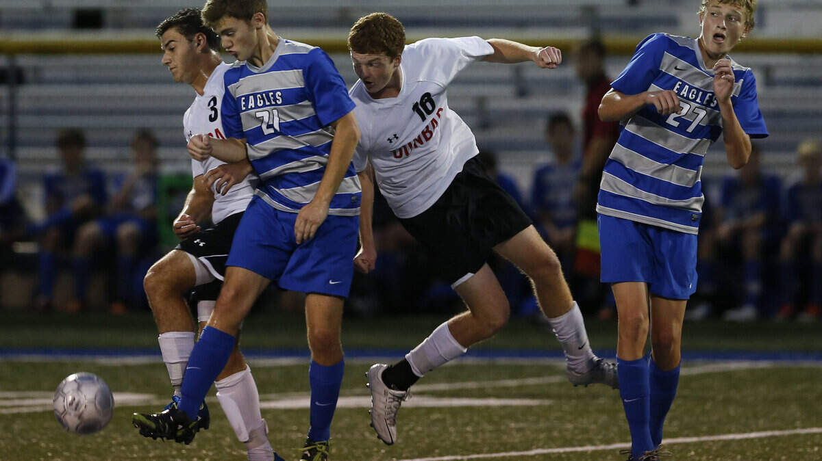 Dunbar's Caleb Clay,3, LCA's Jason Davis,21, Jean-Samuel Poirer, 10, and LCA's Liam Hamilton,27 go for a loose ball as Dunbar defeated Lexington Christian in 43rd district soccer  on Tuesday October 15, 2013 in Lexington, Ky. Photos by Mark Cornelison | Staff      