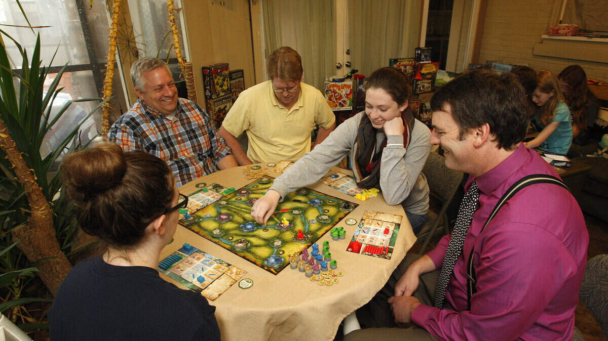 Lexicon members, clockwise from left, Ally Grzywacz, Chris Grzywacz, Phillip Holland, Megan Grzywacz and Greg Franseth played Relic Raiders at Franseth's home Monday. Chris Grzywacz, Holland and Franseth founded Lexicon, which is sponsoring a convention in May for lovers of board games.  