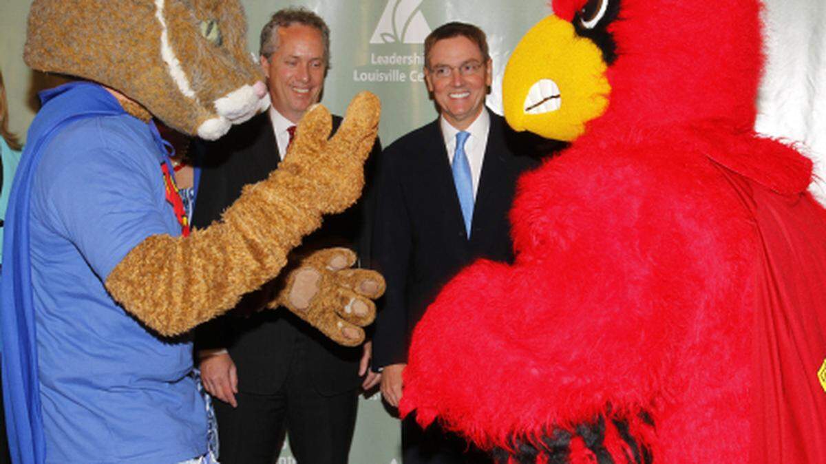 Lexington Mayor Jim Gray, right  and Louisville Mayor Greg  Fischer joked with their respective schools mascots during a Leadership Louisville meeting about the importance of Lexington and Louisville cooperating on economic development  on  Thursday August 11, 2011 in Louisville, Ky. Photo by Mark Cornelison | Staff