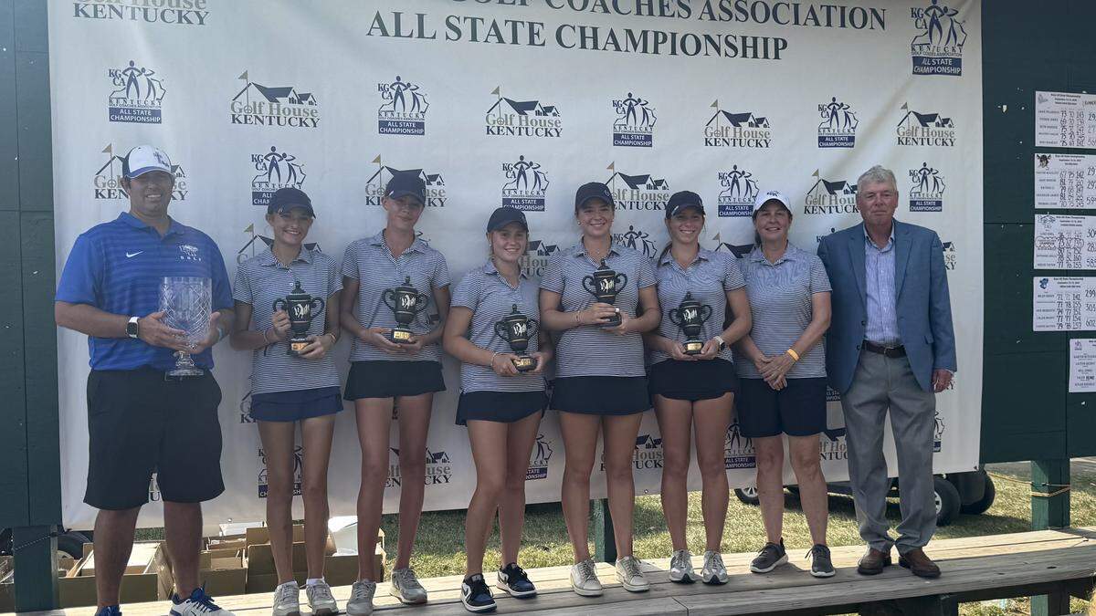 Lexington Christian’s girls golf team poses with their first-place trophies after winning the All State Championships at the University Club of Kentucky on Sunday. From left are LCA head coach Matt Soale, Elle Chamberland, Piper Dunn, Caroline Lankford, Carter Lankford, Grace Soale and assistant coach Kelly Oliver with Wes Martin, co-executive director of the Kentucky Golf Coaches Association.