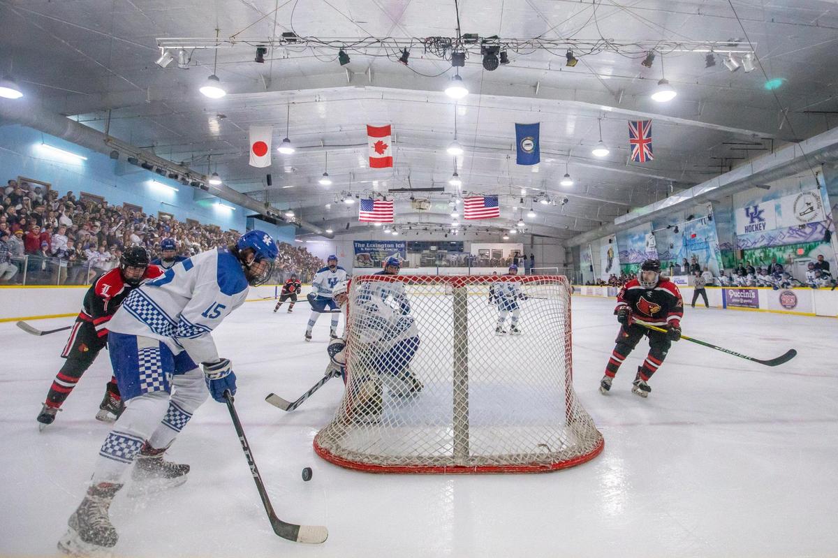 University of Kentucky player Zack Bartuce (15) tries to clear the puck from behind the net during a game against Louisville in January.