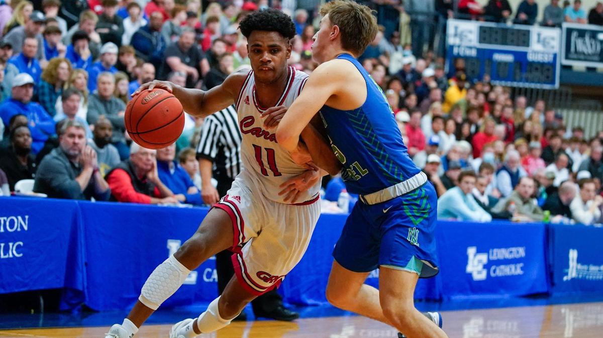 Jerone Morton (11) of Clark County drives against North Laurel’s Kyler Elza (15) during a holiday tournament in Lexington.