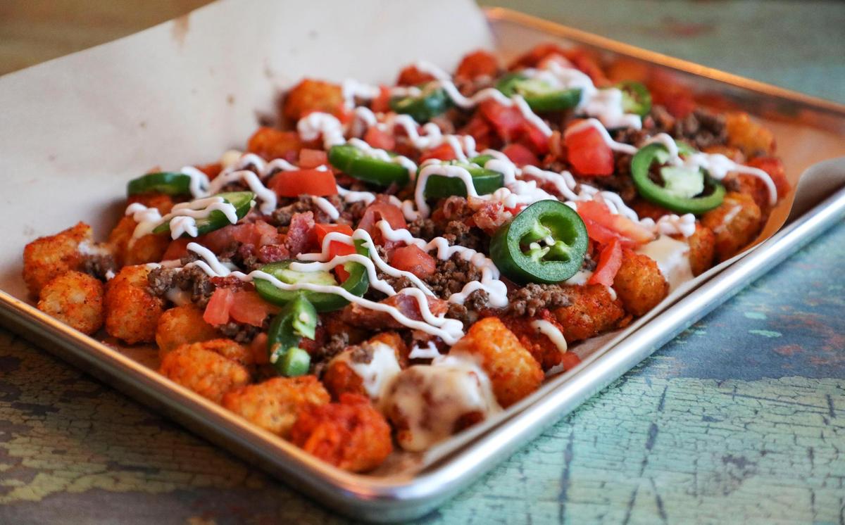 The Rupp It Up tots, with chile con queso, ground beef, bacon, jalapeños, diced tomatoes, and sour cream ($12) at Tilty Bob’s vintage arcade bar and restaurant.