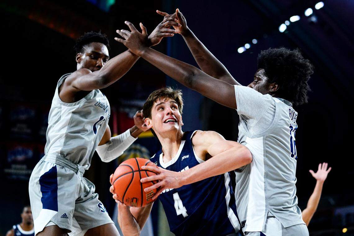 KC Ndefo, left, and Clarence Rupert of Saint Peter’s double-teamed Monmouth’s Walker Miller during last weekend’s Metro Atlantic Athletic Conference Tournament championship game. Statistically, Saint Peter’s is among the best defensive teams in the nation.