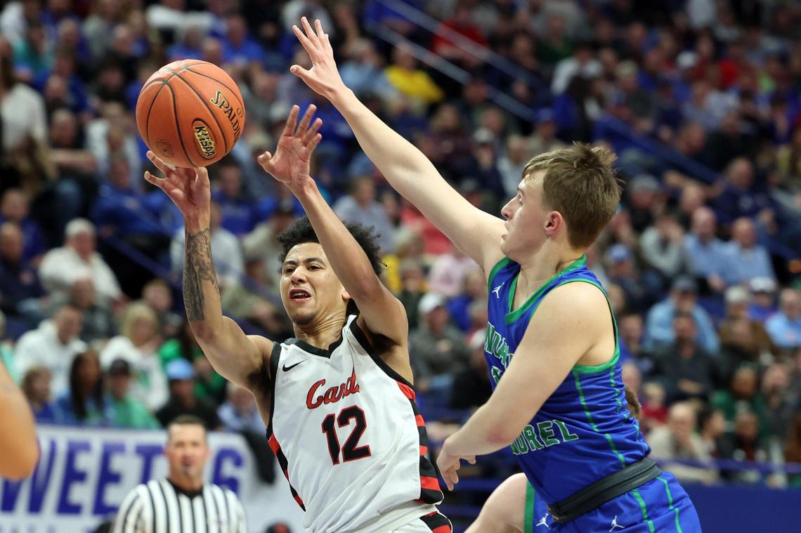 North Laurel’s Kyler Elza, right, pressures George Rogers Clark’s Sam Parrish (12) during their first-round state tournament game in Rupp Arena on Thursday night. Parrish scored 15 of his 19 points in the first half.